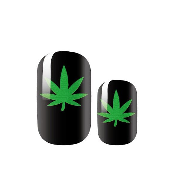 Two black nails with green cannabis leaf designs on a white background