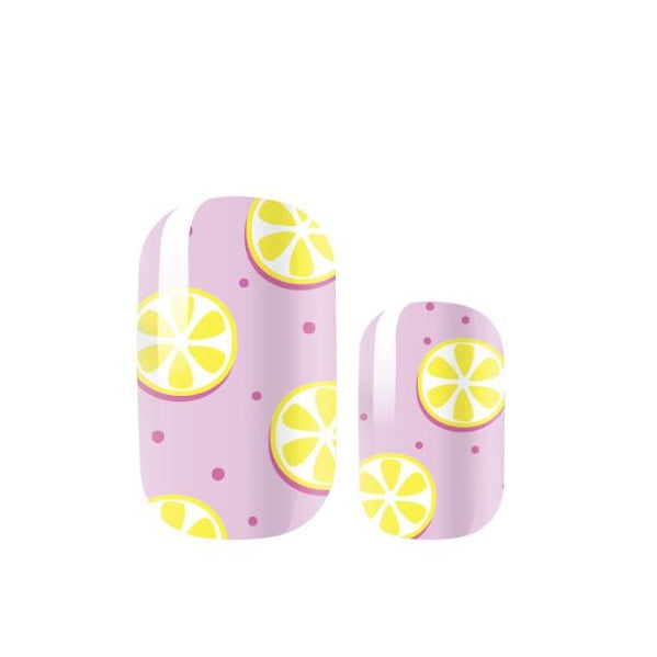 Nail wraps that are light pink and have a yellow lemon slice and dark pink polka dot pattern