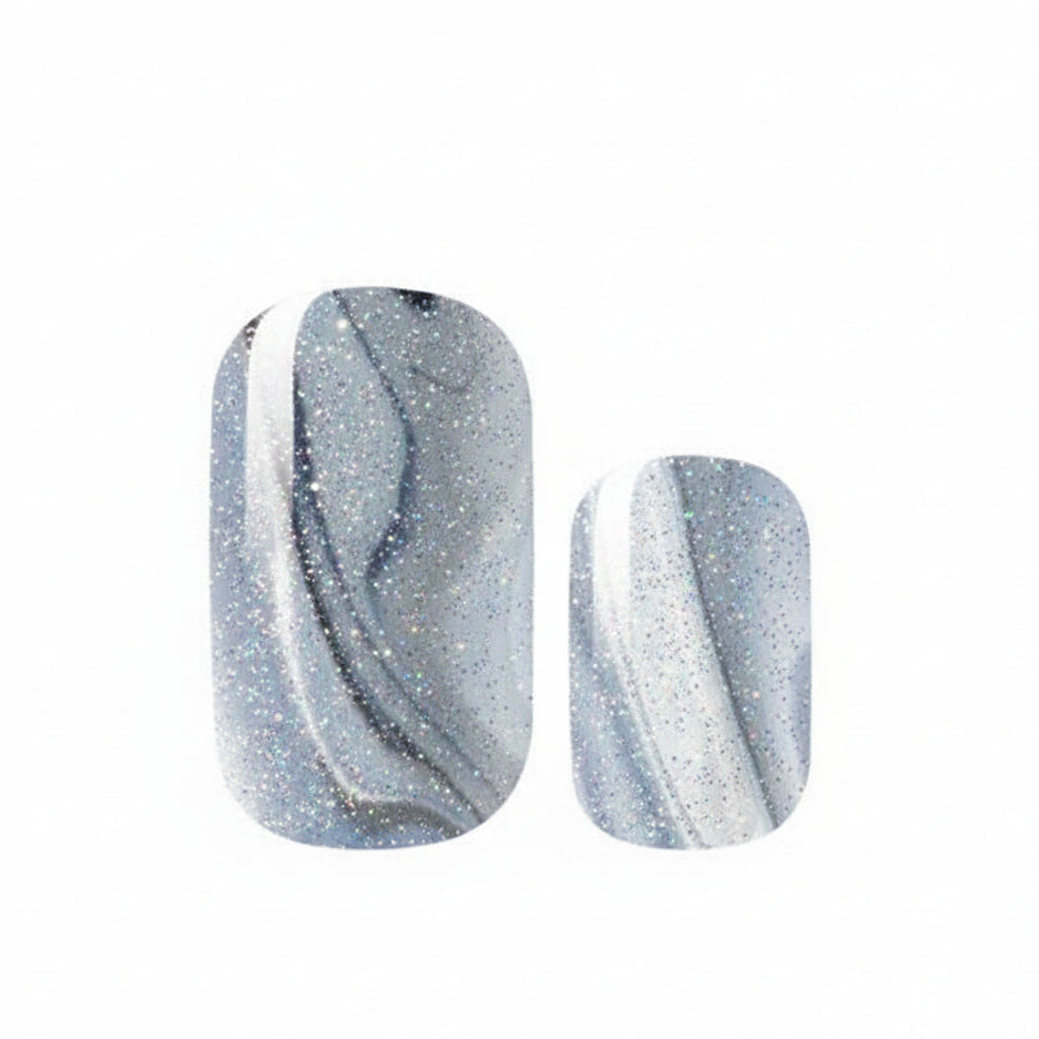 Pair of blue and white marbled nail art stickers on a white background
